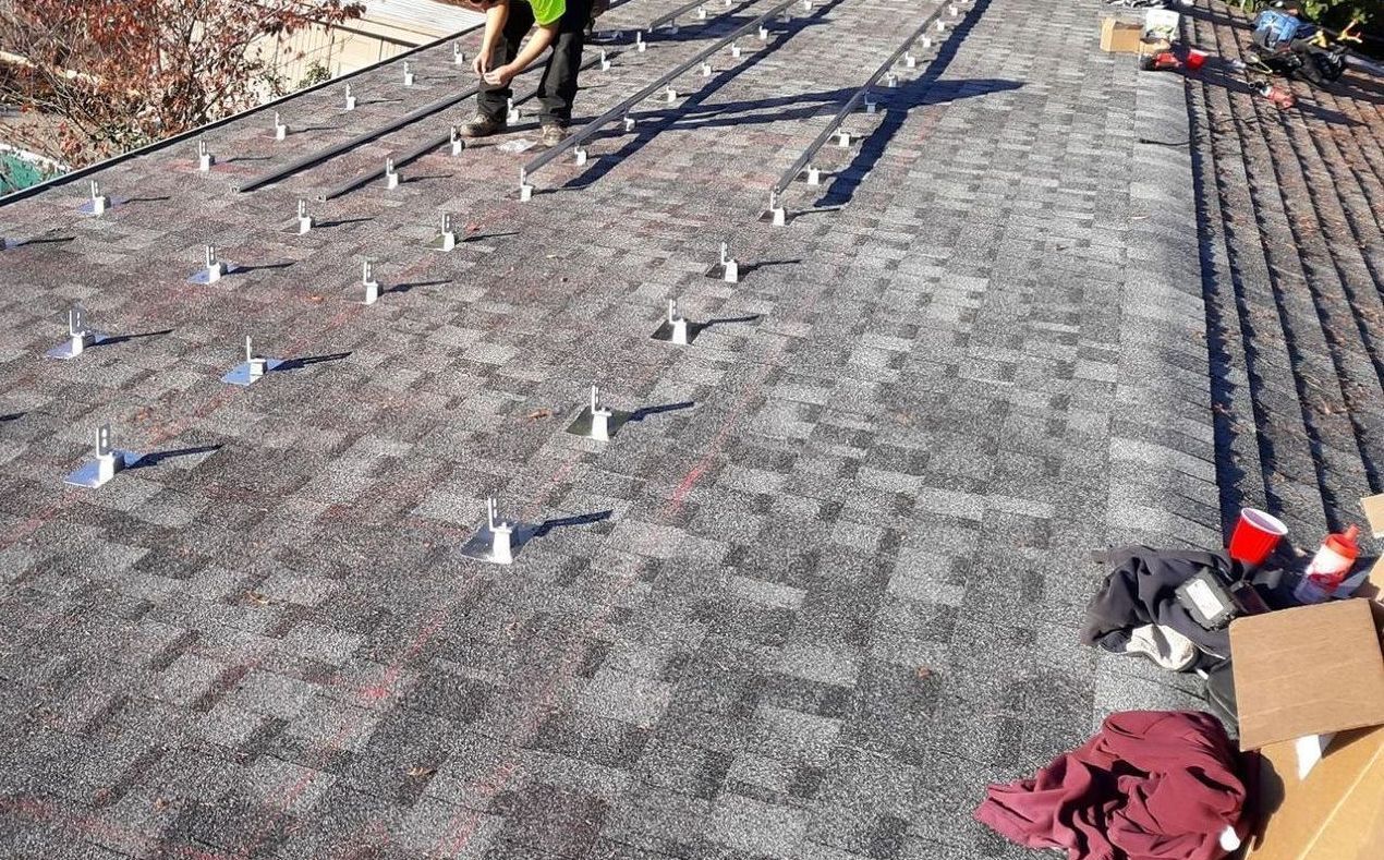 A person is working on a roof with a lot of nails on it from Washington Roofing Services near Arlington WA
